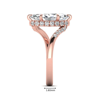 Marquise cut lab grown diamond engagement ring featuring a hidden halo, bypass shank, prong setting, and round accent diamonds in a rose gold tone design.