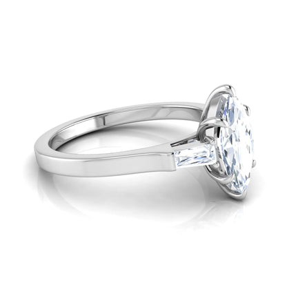 Marquise cut lab grown diamond engagement ring featuring a 0.95 carat IGI certified center diamond with baguette side diamonds in a white gold three stone setting.