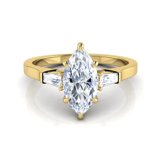 Marquise cut lab grown diamond engagement ring featuring a 0.95 carat IGI certified center diamond with baguette side diamonds in a yellow gold three stone setting.