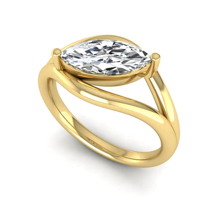 Marquise cut lab grown diamond open frame solitaire engagement ring in a yellow gold sculptural setting