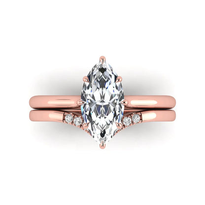 Marquise cut lab grown diamond bypass engagement ring with round side diamonds in a prong setting and rose gold tone band.