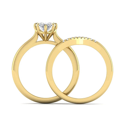 Marquise cut lab grown diamond bypass engagement ring with round side diamonds in a prong setting and yellow gold tone band.
