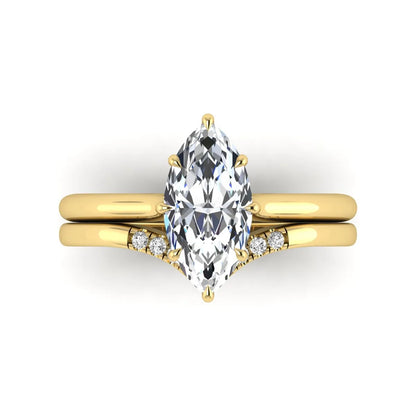 Marquise cut lab grown diamond bypass engagement ring with round side diamonds in a prong setting and yellow gold tone band.