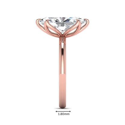 Marquise cut lab grown diamond solitaire engagement ring with six prong setting in rose gold tone featuring an elongated elegant design.