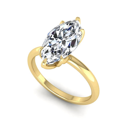 Marquise cut lab grown diamond solitaire engagement ring with six prong setting in yellow gold tone featuring an elongated elegant design.
