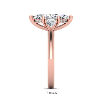 Marquise cut lab grown diamond three stone engagement ring with prong setting, round and pear side diamonds, rose gold tone shown for design reference.