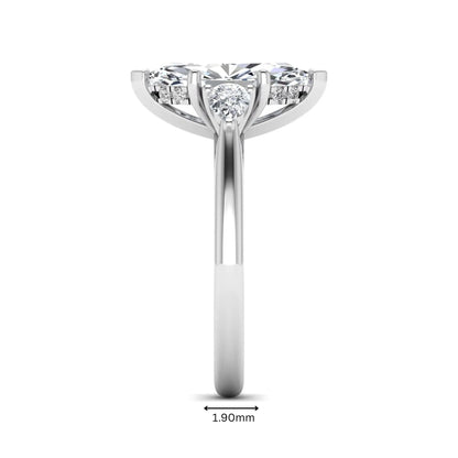Marquise cut lab grown diamond three stone engagement ring with prong setting, round and pear side diamonds, white gold tone shown for design reference.