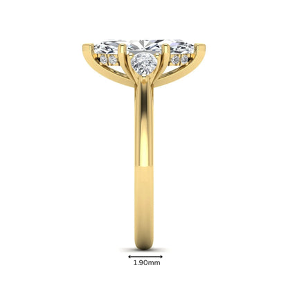 Marquise cut lab grown diamond three stone engagement ring with prong setting, round and pear side diamonds, yellow gold tone shown for design reference.
