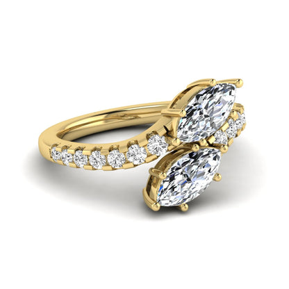 Marquise and round cut lab grown diamond bypass ring with prong setting in yellow gold tone.