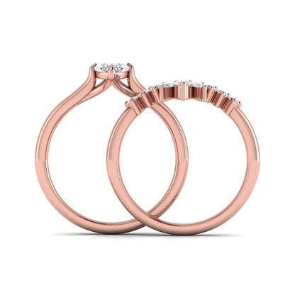 Marquise solitaire lab grown diamond bridal ring set featuring a four-prong marquise center diamond with a crown-inspired contour wedding band accented by pear and round diamonds in rose gold