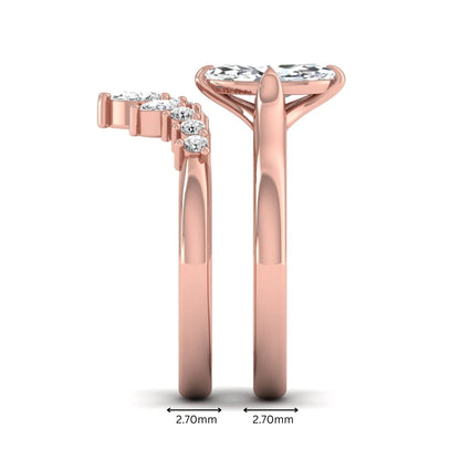 Marquise solitaire lab grown diamond bridal ring set featuring a four-prong marquise center diamond with a crown-inspired contour wedding band accented by pear and round diamonds in rose gold