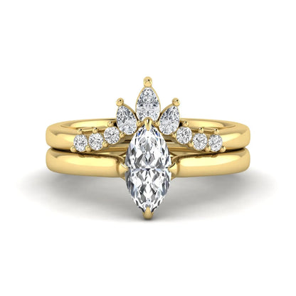 Marquise solitaire lab grown diamond bridal ring set featuring a four-prong marquise center diamond with a crown-inspired contour wedding band accented by pear and round diamonds in yellow gold