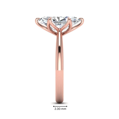 Marquise cut lab grown diamond solitaire engagement ring with six-prong setting and rose gold tone band.