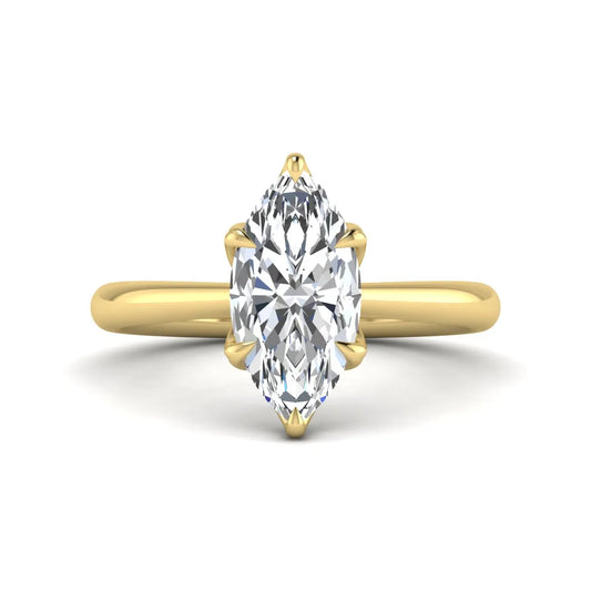 Marquise cut lab grown diamond solitaire engagement ring with six-prong setting and yellow gold tone band.