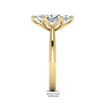 Marquise cut lab grown diamond solitaire engagement ring with six-prong setting and yellow gold tone band.