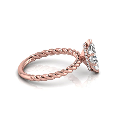 Marquise cut lab grown diamond engagement ring with a twisted band and hidden round accent diamonds in rose gold style.