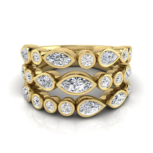 Multi shape lab grown diamond stacking ring featuring marquise, pear, and round bezel set diamonds totaling 1.50 carats in yellow gold.