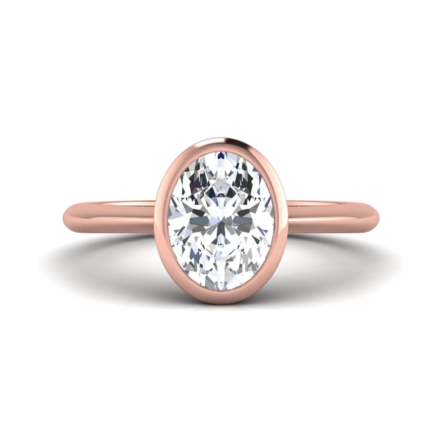 Oval cut lab grown diamond solitaire engagement ring in a bezel setting with a rose gold tone minimalist band.