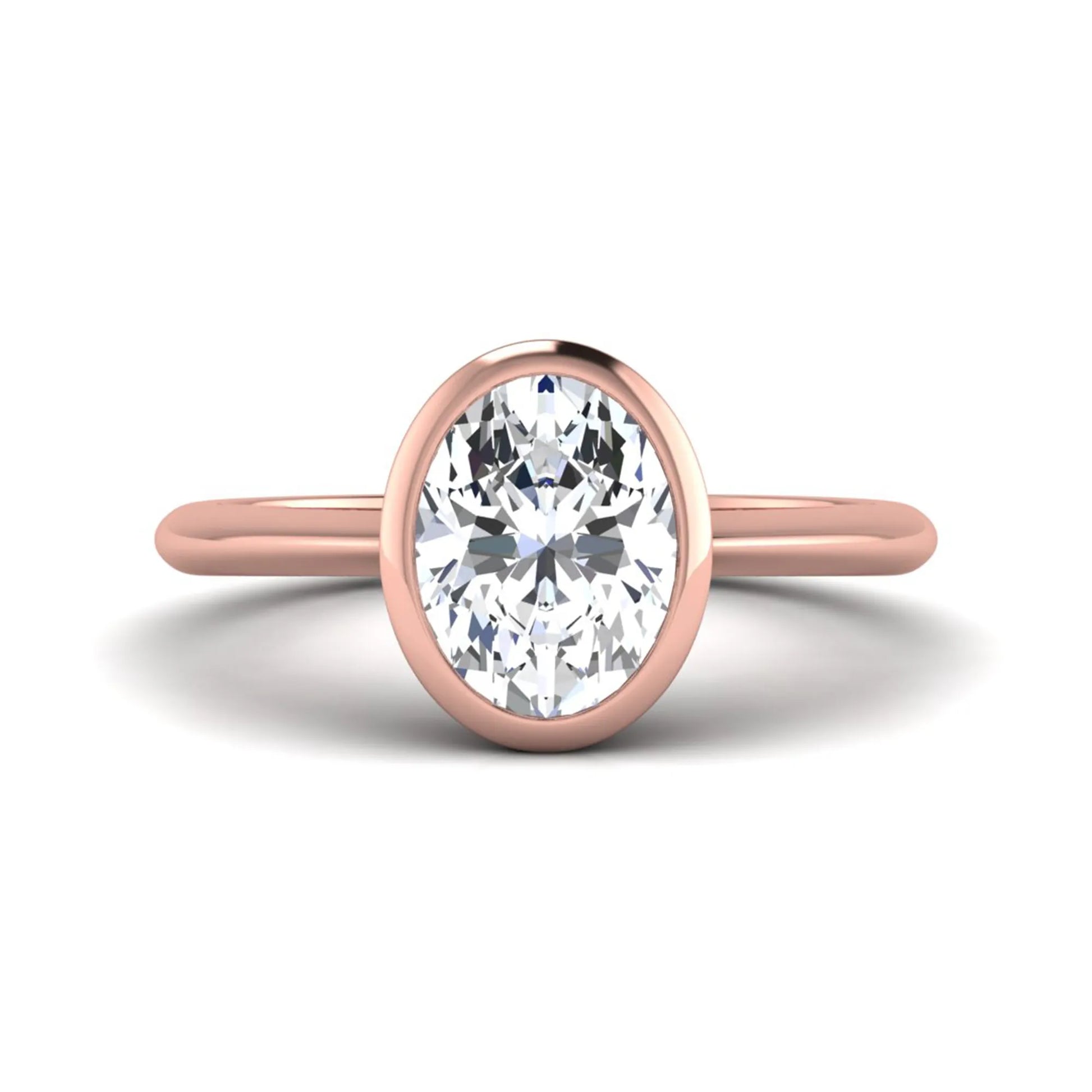 Oval cut lab grown diamond solitaire engagement ring in a bezel setting with a rose gold tone minimalist band.
