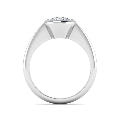 Oval cut lab grown diamond solitaire engagement ring in a bezel setting with a white gold tone minimalist band.