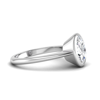 Oval cut lab grown diamond solitaire engagement ring in a bezel setting with a white gold tone minimalist band.