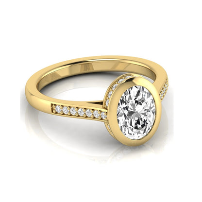 Oval cut lab grown diamond engagement ring featuring a 1.21 carat IGI certified center diamond in a modern bezel setting with pavé diamond shoulders and a polished yellow gold band.