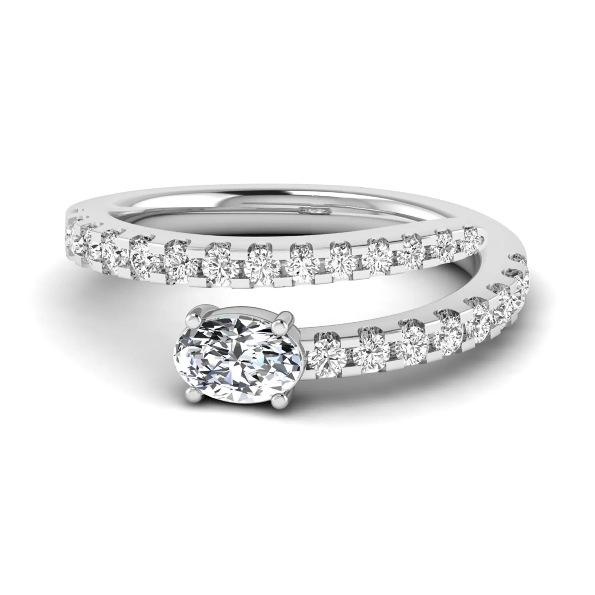 Oval cut lab grown diamond bypass engagement ring with round pavé accent diamonds in a four-prong setting in white gold