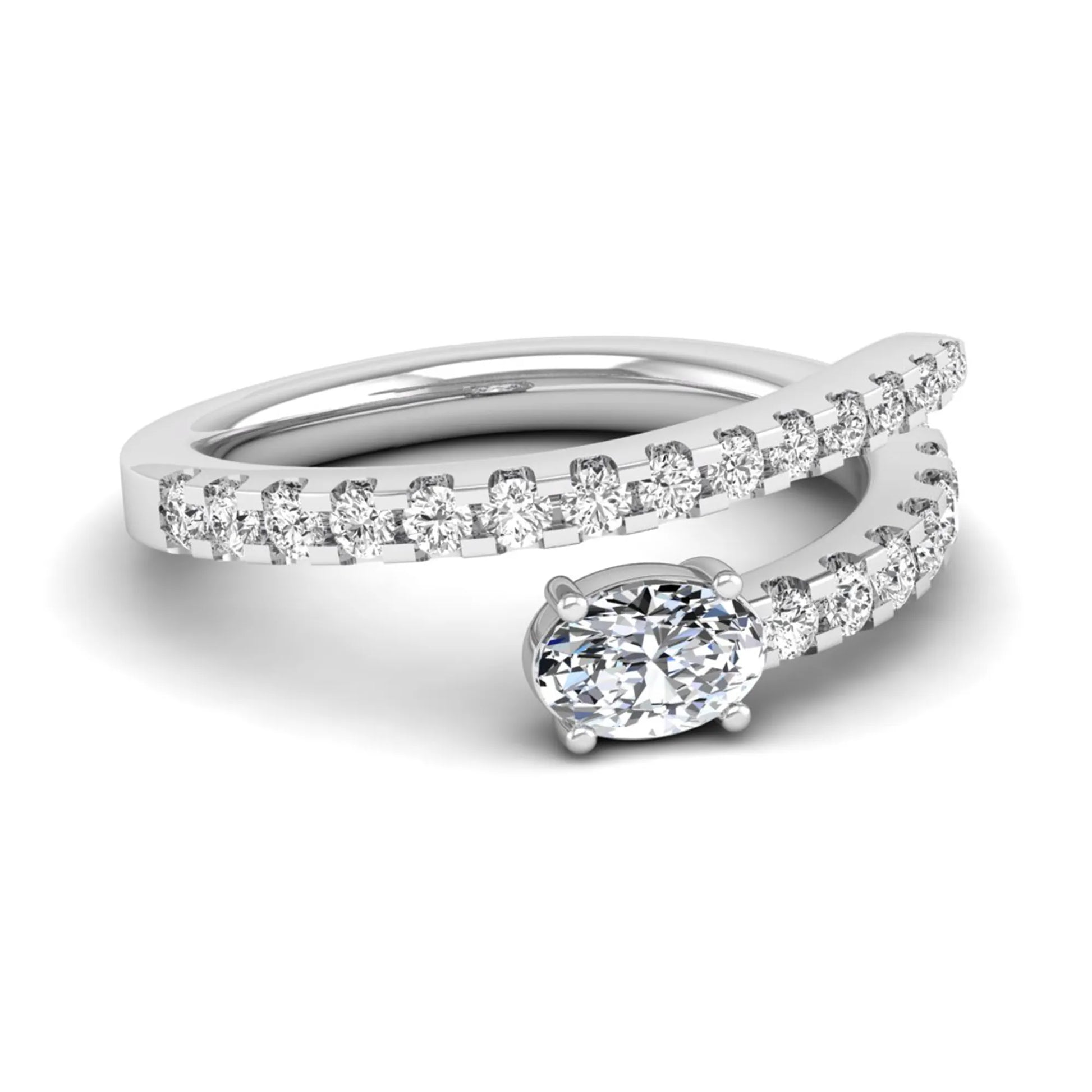 Oval cut lab grown diamond bypass engagement ring with round pavé accent diamonds in a four-prong setting in white gold