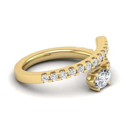 Oval cut lab grown diamond bypass engagement ring with round pavé accent diamonds in a four-prong setting in yellow gold