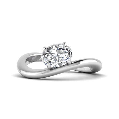 Oval cut lab grown diamond curved solitaire engagement ring with a four-prong setting in white gold