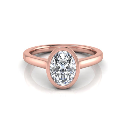 Oval cut lab grown diamond bezel solitaire engagement ring featuring a 0.75 carat center diamond in polished rose gold.