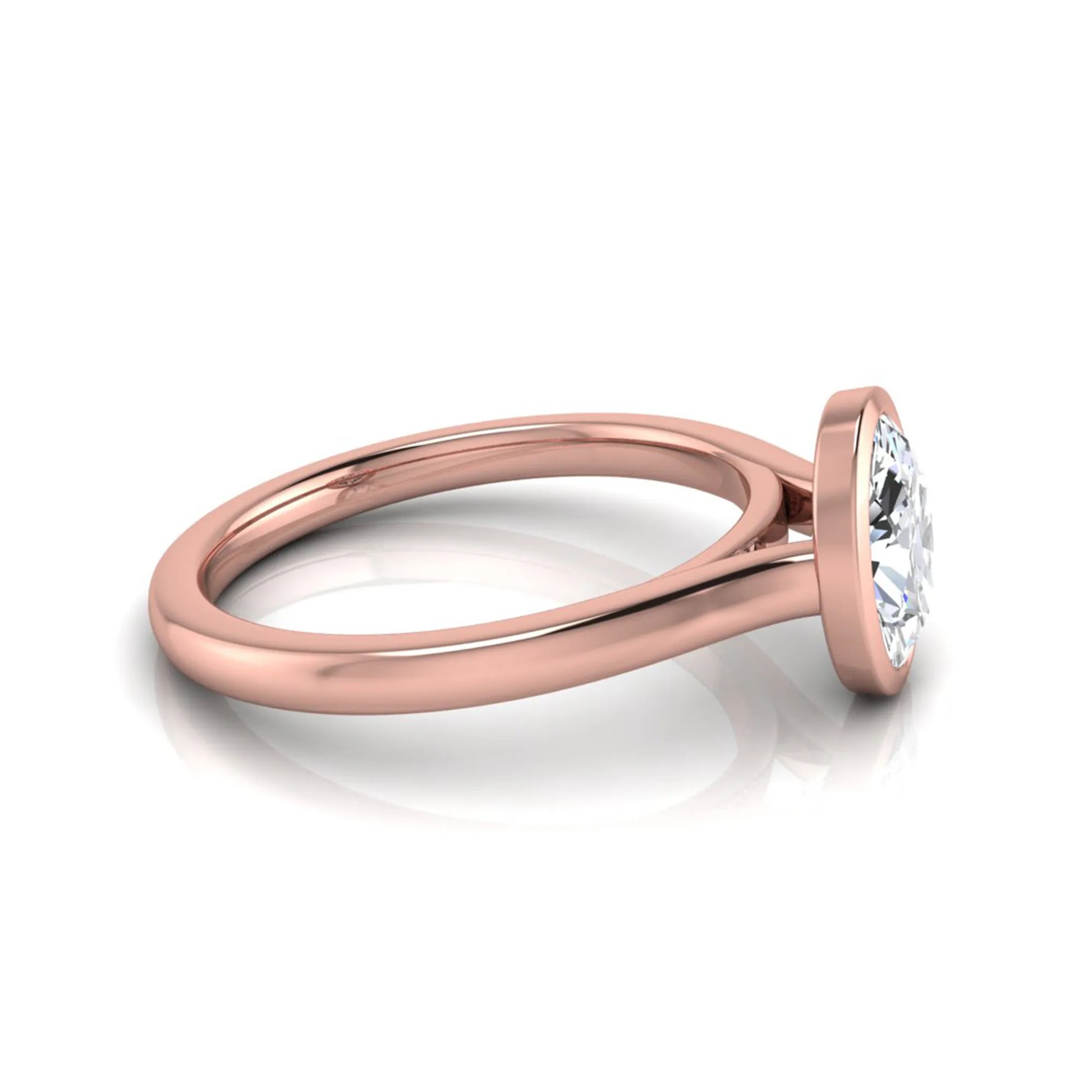 Oval cut lab grown diamond bezel solitaire engagement ring featuring a 0.75 carat center diamond in polished rose gold.