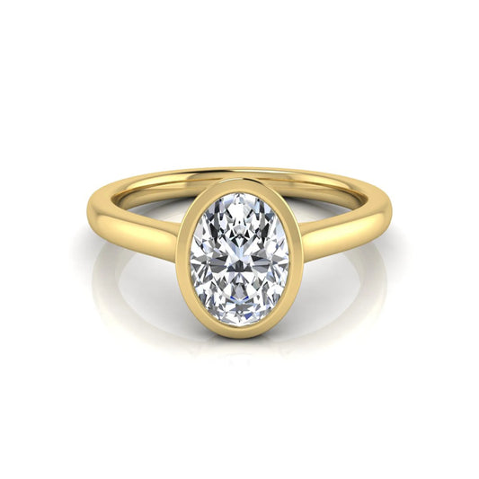 Oval cut lab grown diamond bezel solitaire engagement ring featuring a 0.75 carat center diamond in polished yellow gold.