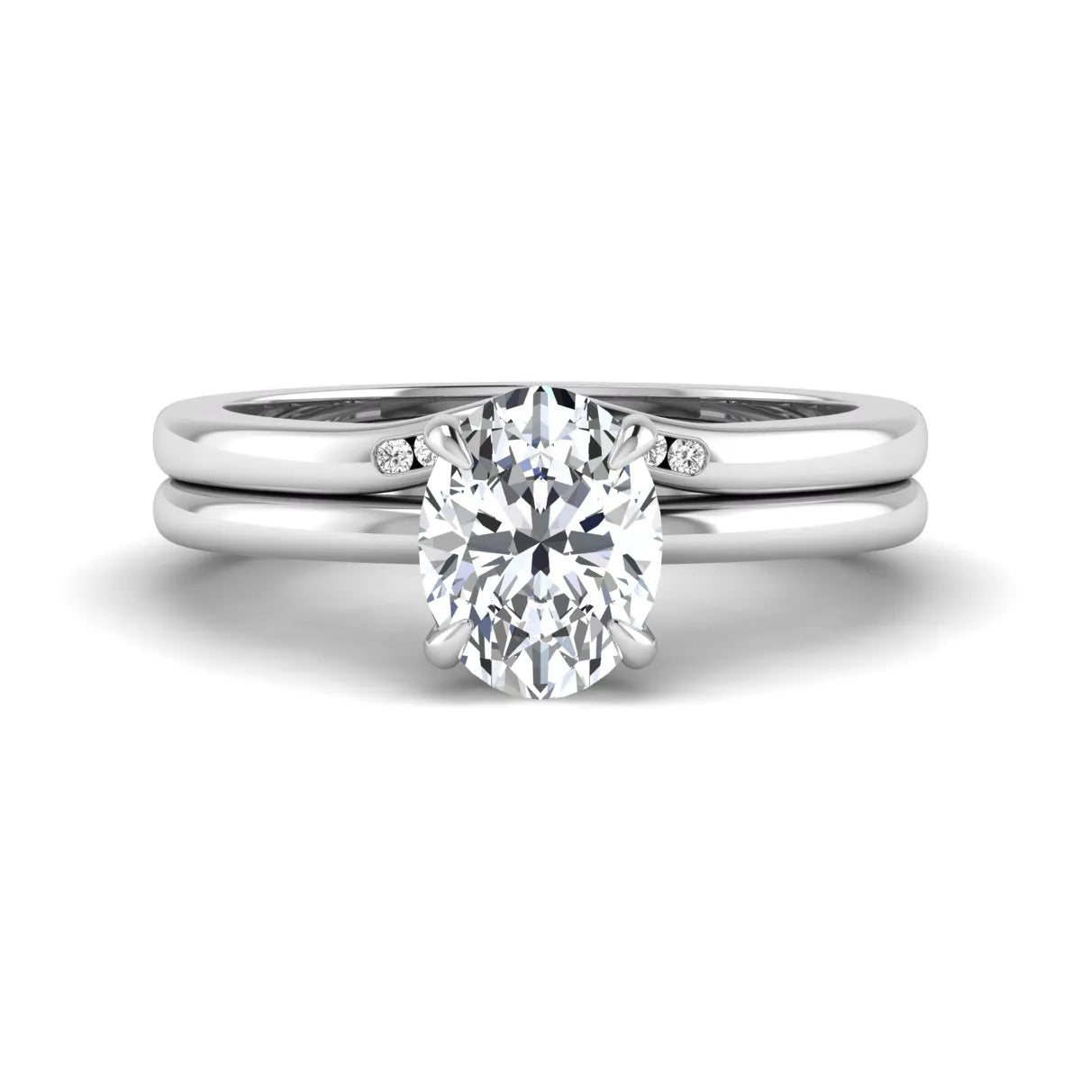 IGI certified oval cut lab grown diamond bridal ring set featuring a hidden halo engagement ring with a matching curved diamond wedding band in white gold.