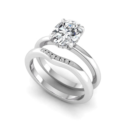IGI certified oval cut lab grown diamond bridal ring set featuring a hidden halo engagement ring with a matching curved diamond wedding band in white gold.