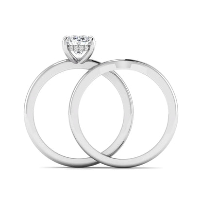 IGI certified oval cut lab grown diamond bridal ring set featuring a hidden halo engagement ring with a matching curved diamond wedding band in white gold.