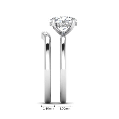 IGI certified oval cut lab grown diamond bridal ring set featuring a hidden halo engagement ring with a matching curved diamond wedding band in white gold.