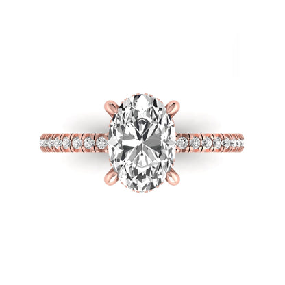 Oval cut lab grown diamond engagement ring featuring a 2.30 carat IGI certified center diamond with hidden halo and pavé round side diamonds in rose gold.