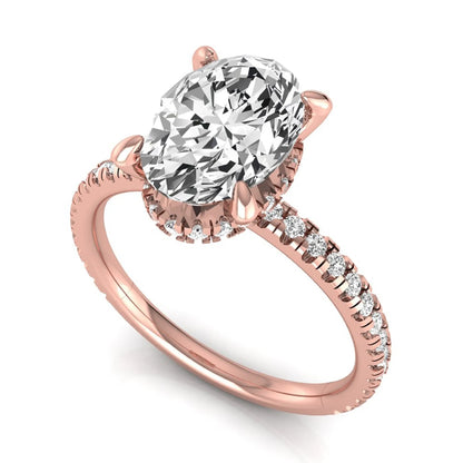 Oval cut lab grown diamond engagement ring featuring a 2.30 carat IGI certified center diamond with hidden halo and pavé round side diamonds in rose gold.