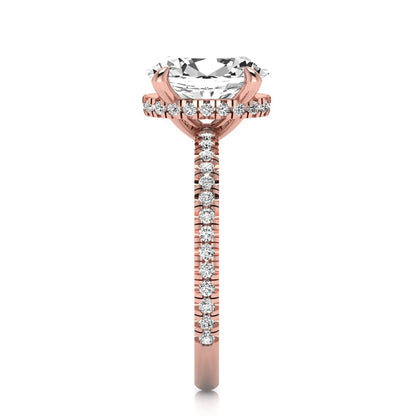 Oval cut lab grown diamond engagement ring featuring a 2.30 carat IGI certified center diamond with hidden halo and pavé round side diamonds in rose gold.