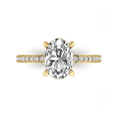 Oval cut lab grown diamond engagement ring featuring a 2.30 carat IGI certified center diamond with hidden halo and pavé round side diamonds in yellow gold.