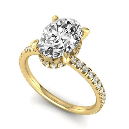 Oval cut lab grown diamond engagement ring featuring a 2.30 carat IGI certified center diamond with hidden halo and pavé round side diamonds in yellow gold.