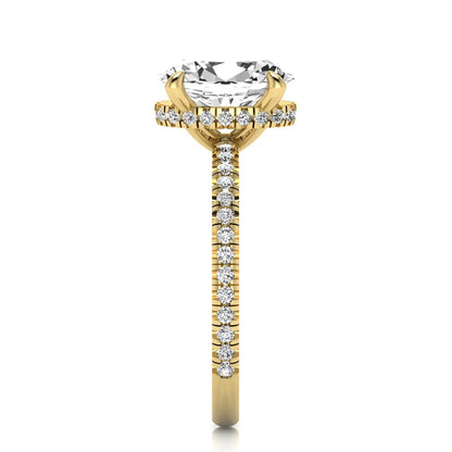 Oval cut lab grown diamond engagement ring featuring a 2.30 carat IGI certified center diamond with hidden halo and pavé round side diamonds in yellow gold.