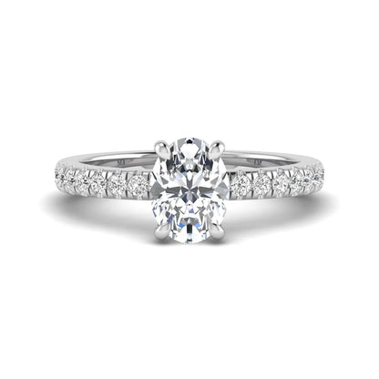 IGI certified oval cut lab grown diamond solitaire accent engagement ring with pavé round diamond band in white gold.