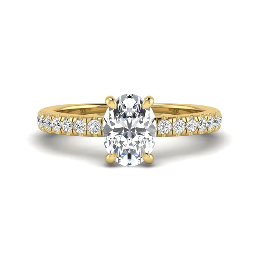 IGI certified oval cut lab grown diamond solitaire accent engagement ring with pavé round diamond band in yellow gold.