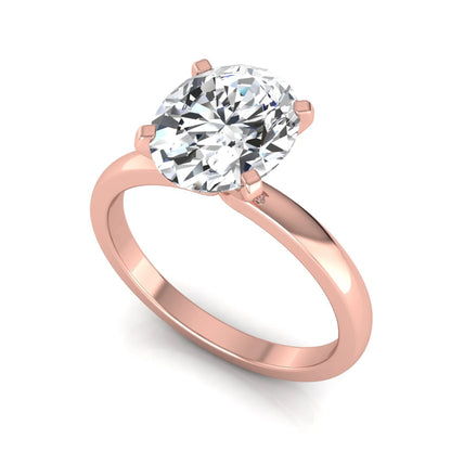 Oval cut lab grown diamond solitaire engagement ring featuring a four-prong setting with a rose gold tone band.