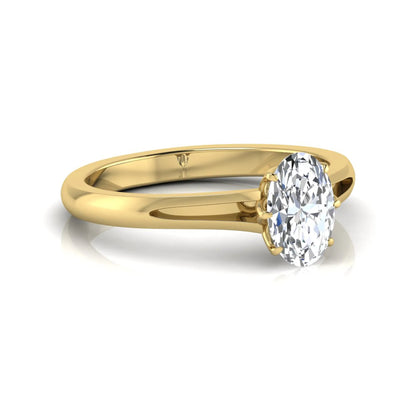 Oval cut lab grown diamond solitaire engagement ring featuring a four-prong setting and elegant split shank band in yellow gold tone.