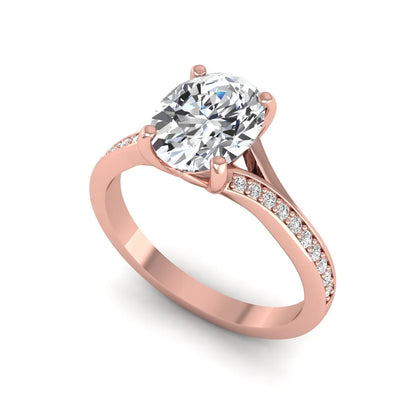 Oval cut lab grown diamond split shank pavé engagement ring with four-prong setting and rose gold tone band.