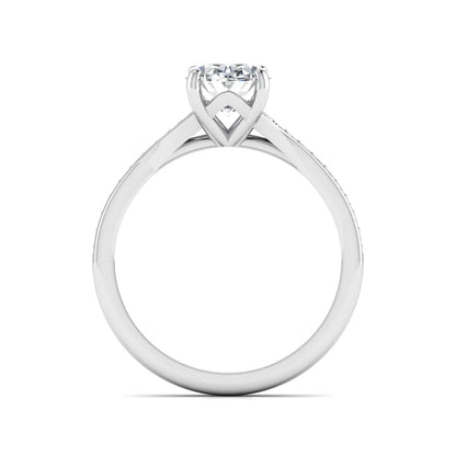 Oval cut lab grown diamond split shank pavé engagement ring with four-prong setting and white gold tone band.
