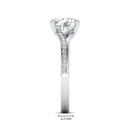 Oval cut lab grown diamond split shank pavé engagement ring with four-prong setting and white gold tone band.